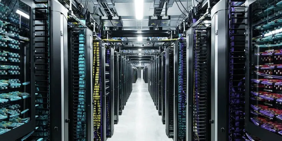 A row of server racks in a modern data center with networking equipment, cable infrastructure, and cooling system, providing reliable and secure IT infrastructure for business